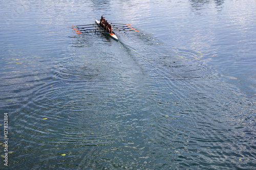 Four women rowing on the tranquil lake