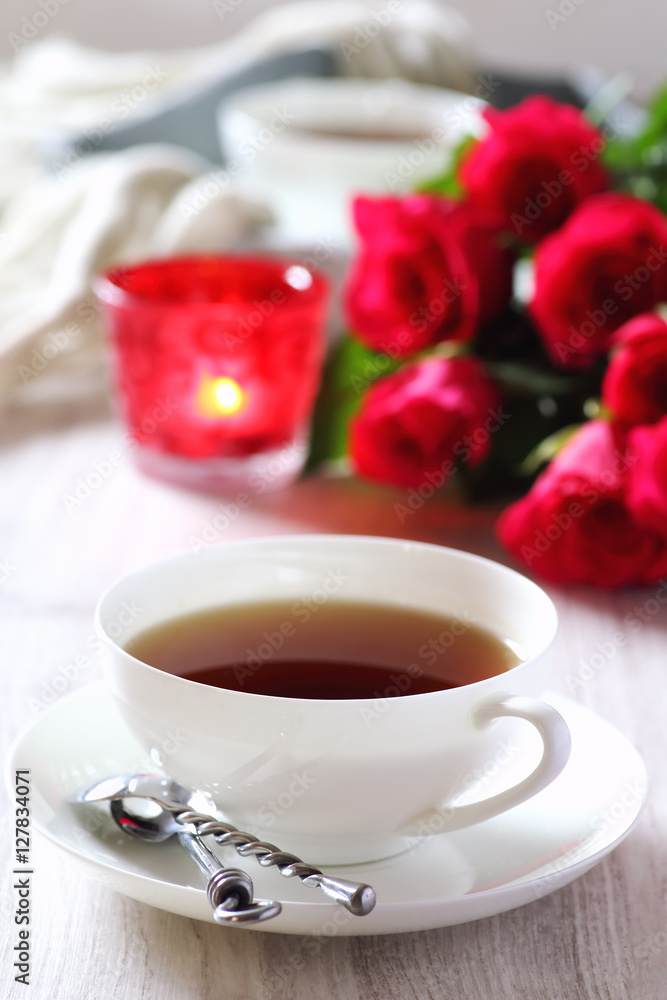 Valentine's Day: Romantic Tea Party with candle and bouquet of Valentine's Day: Romantic Tea Party with candle and bouquet of