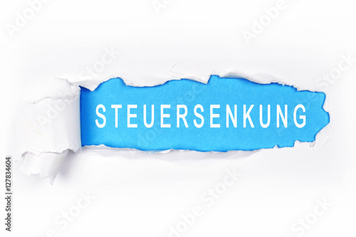 Steuersenkungen - aufgerissener Papierflyer photo