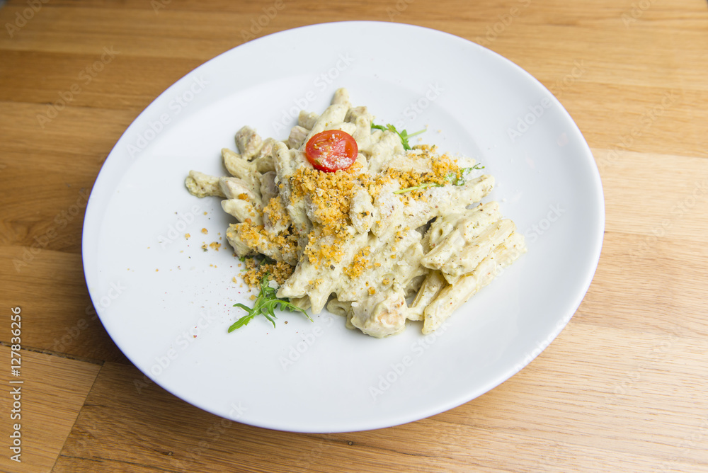 Pasta in cream sauce with chicken meat, tomato, cheese Pasta in cream sauce with chicken meat, tomato, cheese