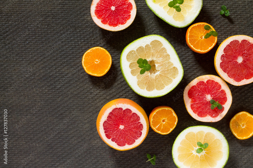 Citrus set of grapefruit and fresh mint on a concrete gray backg Citrus set of grapefruit and fresh mint on a concrete gray backg