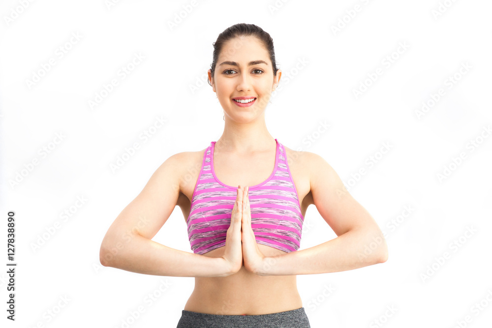 Namaste posture! Woman in sports bra performing signature namaste yoga practice pose - Pilates, Yoga and Sport Training Concept Namaste posture! Woman in sports bra performing signature namaste yoga practice pose - Pilates, Yoga and Sport Training Concept