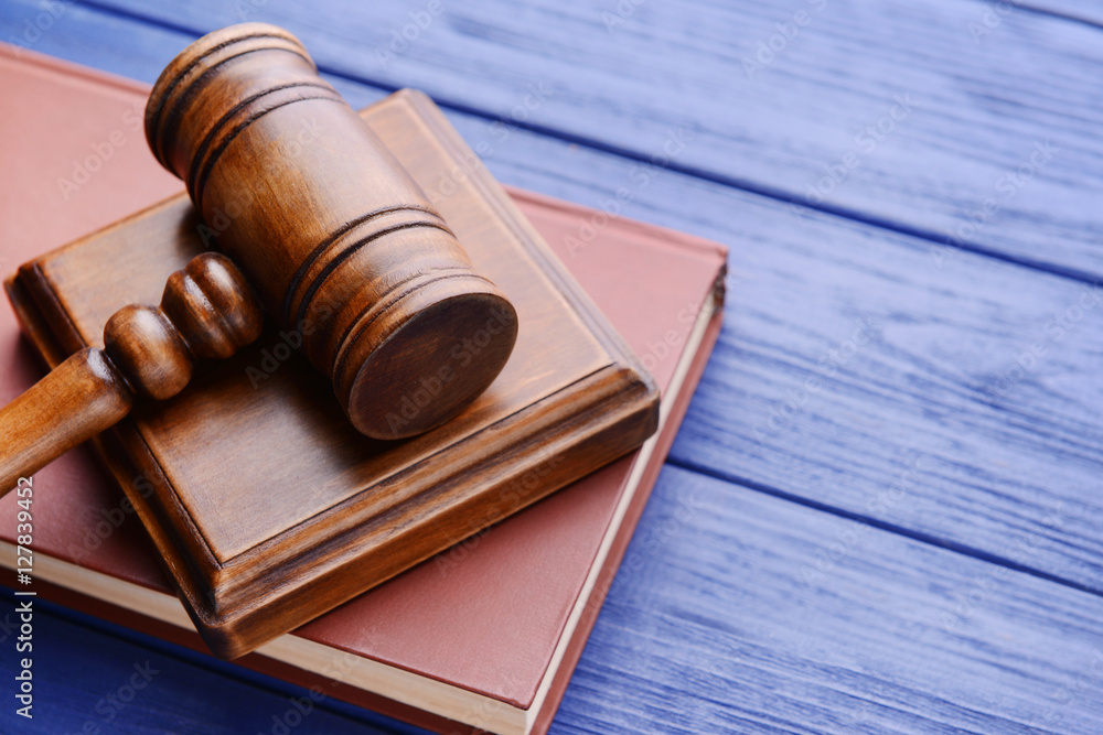 Gavel with sound block and book on wooden background Gavel with sound block and book on wooden background