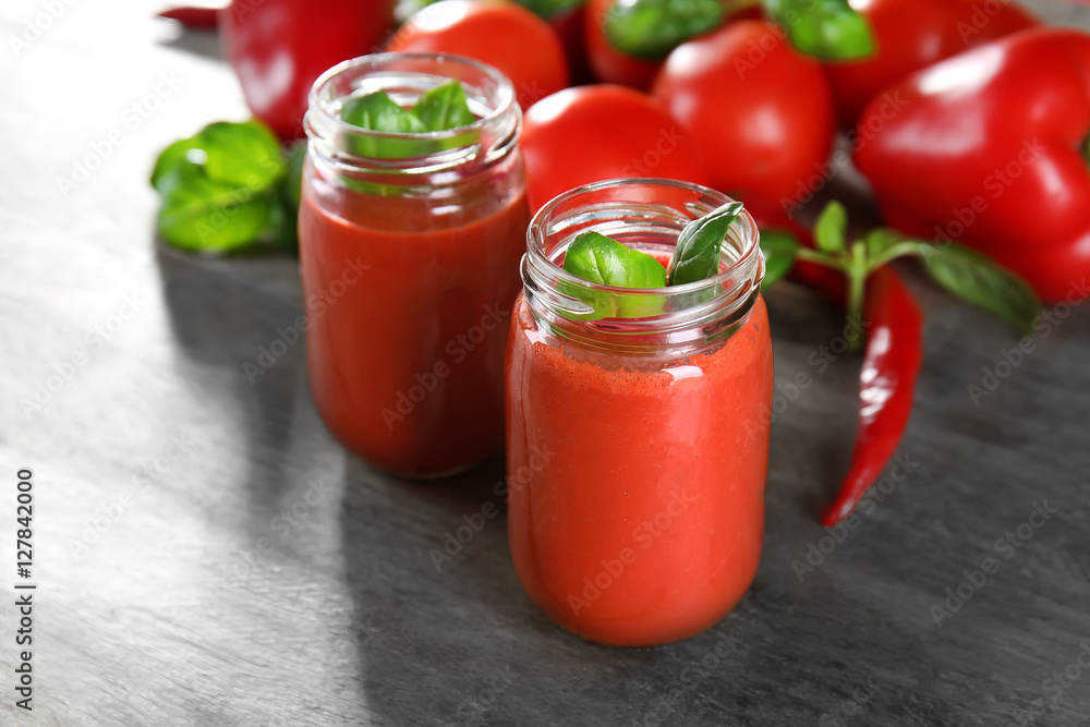 Glass jars with vegetable smoothie on wooden table Glass jars with vegetable smoothie on wooden table