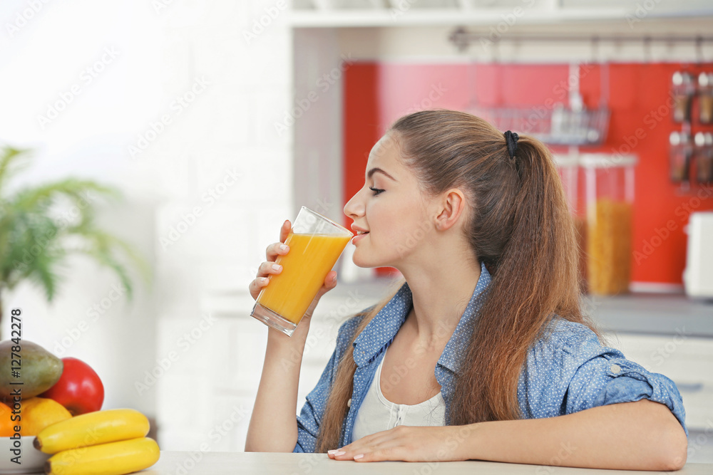Young beautiful woman in kitchen drinking juice Young beautiful woman in kitchen drinking juice