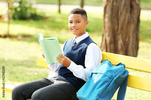 Teenager sitting on bench a...