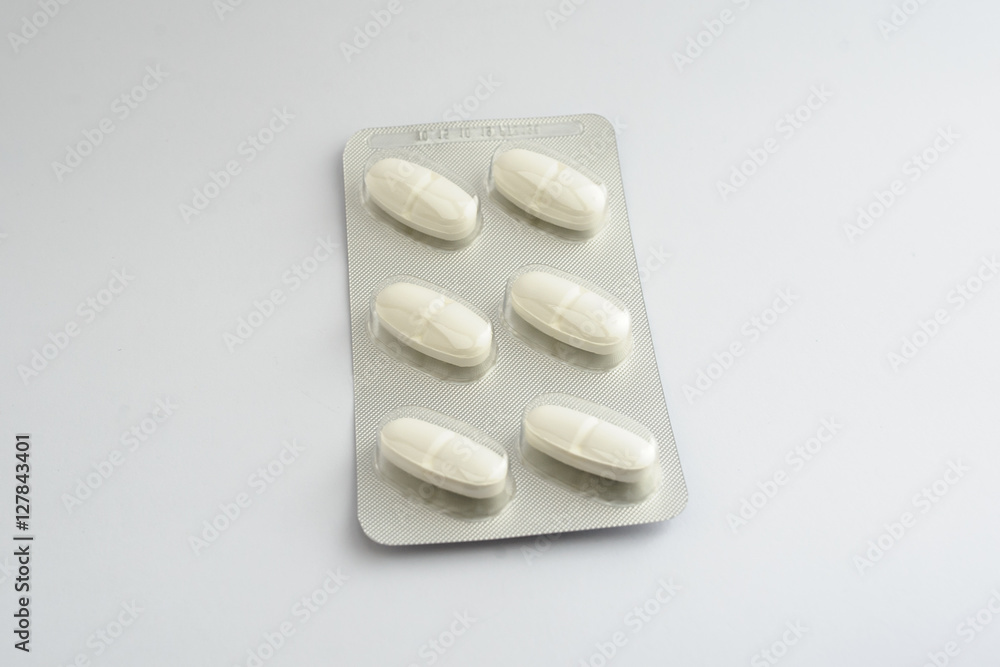 white pills tablets in a blister drugs
