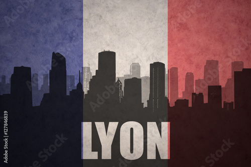 abstract silhouette of the city with text Lyon at the vintage french flag