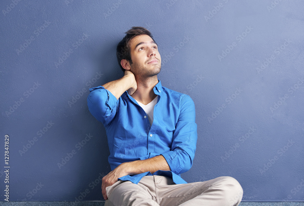 Thinking man portrait. Shot of a thoughtful man in front of the wall. Thinking man portrait. Shot of a thoughtful man in front of the wall.