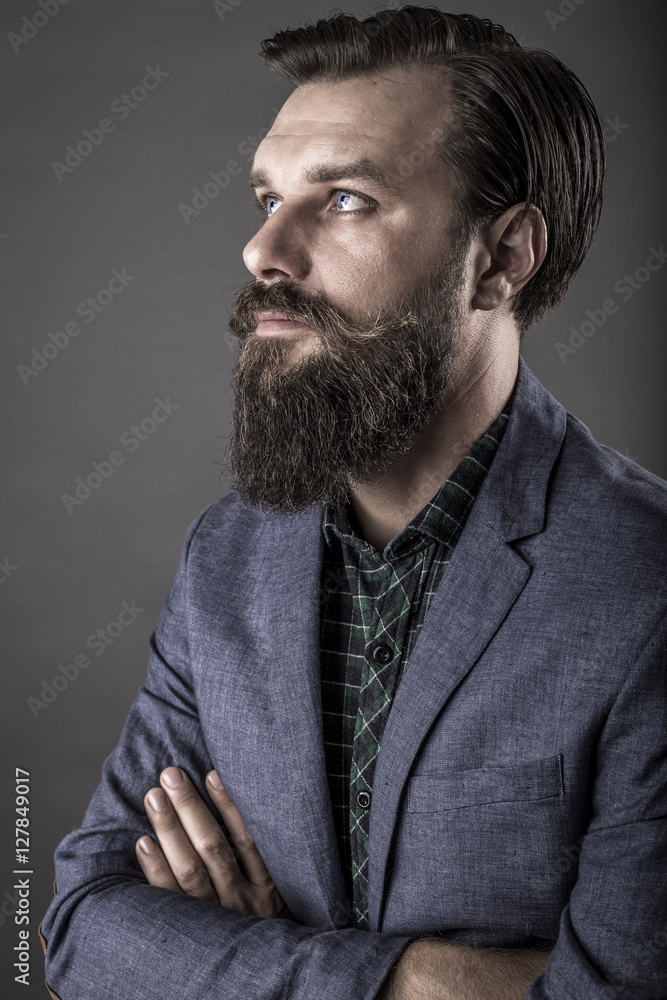 Portrait of an elegant young fashion man with beard and mustache