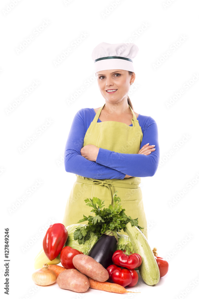 Beautiful young chef next to her fresh vegetables Beautiful young chef next to her fresh vegetables