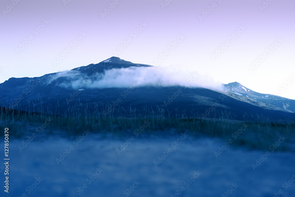 Norway night peak with clouds background