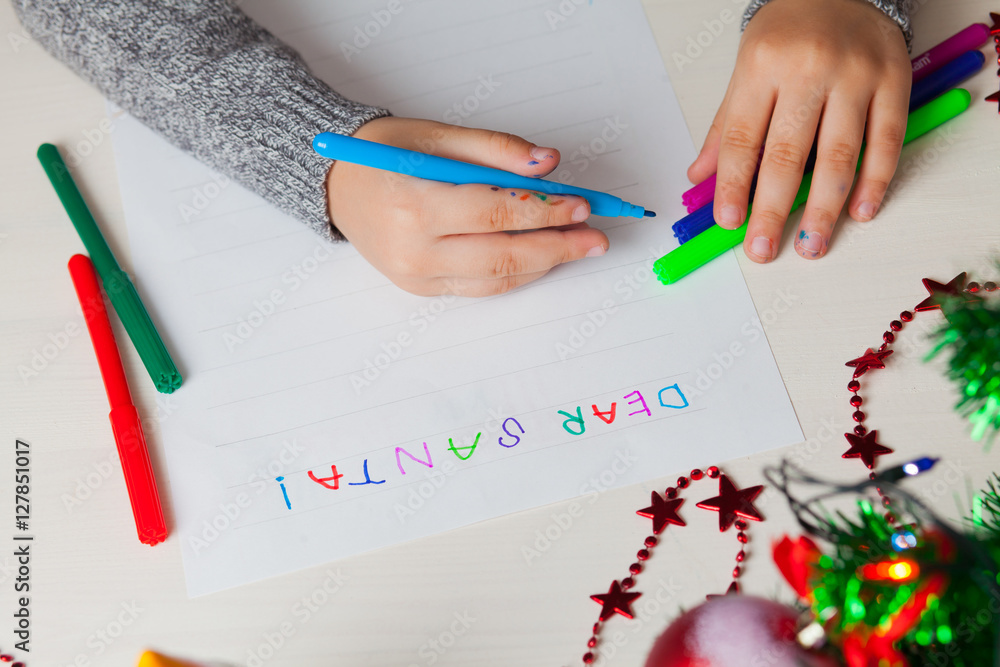 Dear Santa Clous. Child writing letter to Santa Claus at Christm Dear Santa Clous. Child writing letter to Santa Claus at Christm