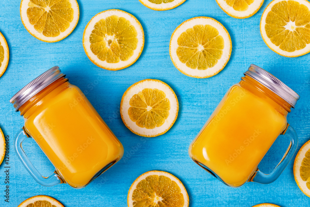Orange juice on a blue background, top view. Orange juice on a blue background, top view.