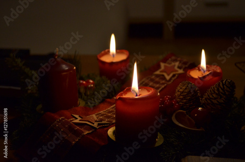 Romantic advent crown with three enlighted candles