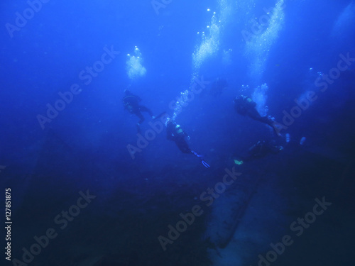 silhouette scuba diving. Sunken ship.