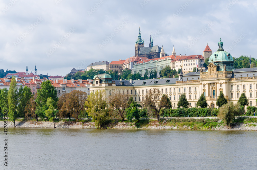 View on the Prague Castle from the river Vltava and on other historical buildings we tree lined walking path