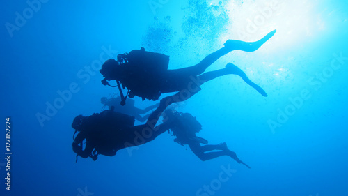Silhouette scuba diving.