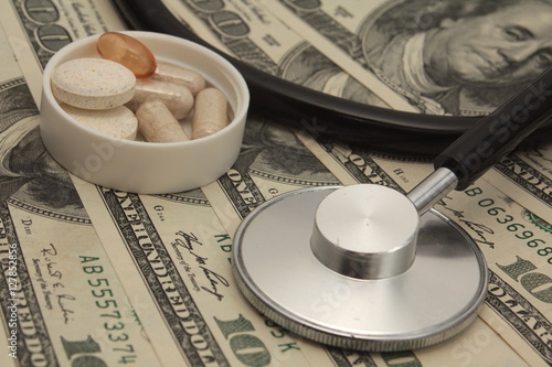 Medical Stethoscope and Pills on Dollars