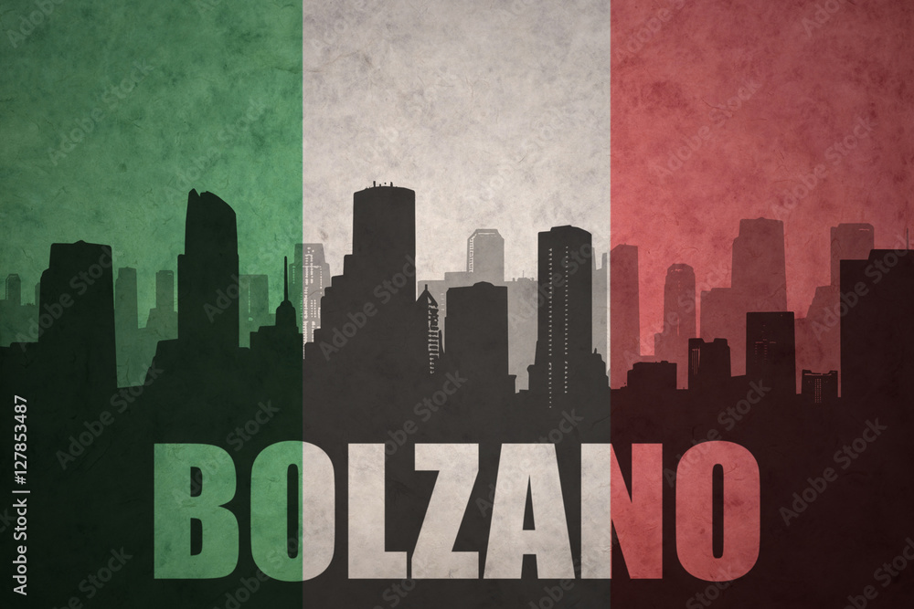 abstract silhouette of the city with text Bolzano at the vintage italian flag