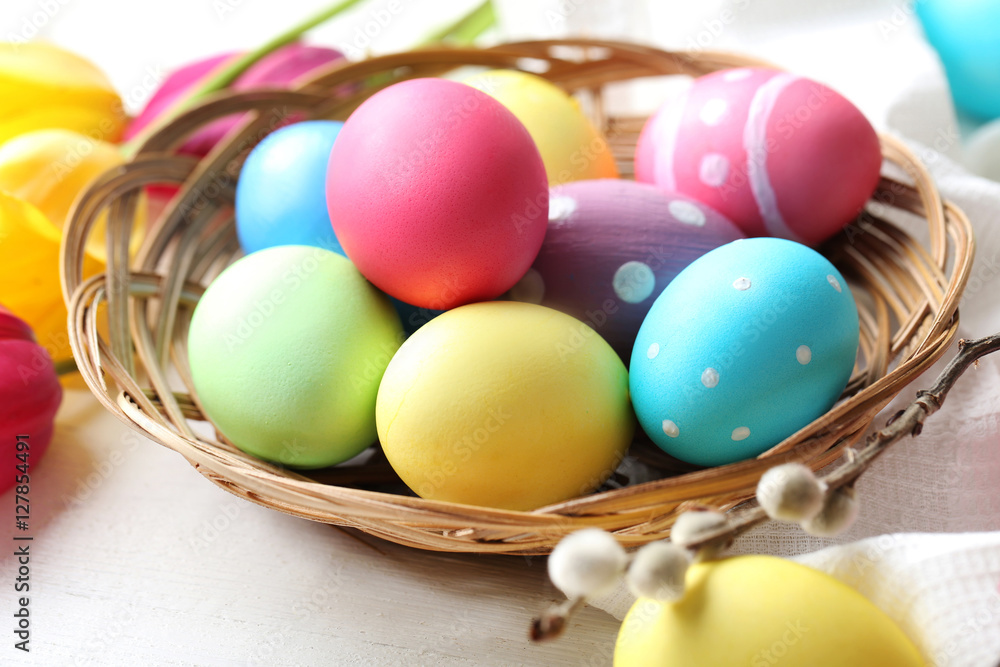 Easter eggs with tulips on a white wooden table Easter eggs with tulips on a white wooden table