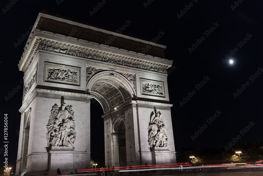 Triumphal arch. Paris. France. View Place Charles de Gaulle. Famous touristic architecture landmark in summer night. Napoleon victory monument. Symbol of french glory. World historical heritage. Toned Triumphal arch. Paris. France. View Place Charles de Gaulle. Famous touristic architecture landmark in summer night. Napoleon victory monument. Symbol of french glory. World historical heritage. Toned