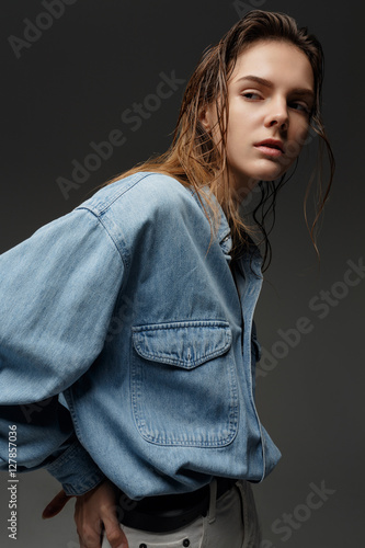 portrait of happy young woman, posing in jean shirt and white je photo