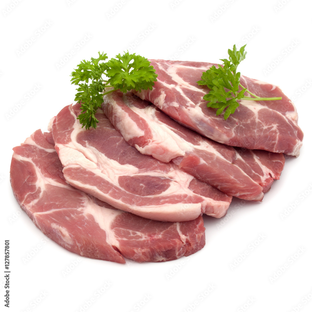Raw pork neck chop meat with parsley herb leaves garnish isolate Raw pork neck chop meat with parsley herb leaves garnish isolate