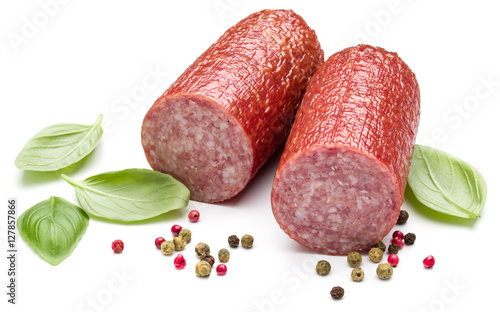 Salami smoked sausage, basil leaves and peppercorns isolated on