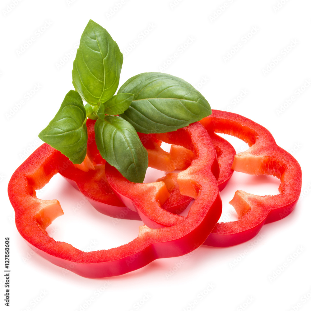 Red sweet bell pepper slices and basil leaves isolated on white Red sweet bell pepper slices and basil leaves isolated on white
