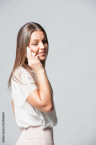 Portrait of smiling young business woman holding a phone