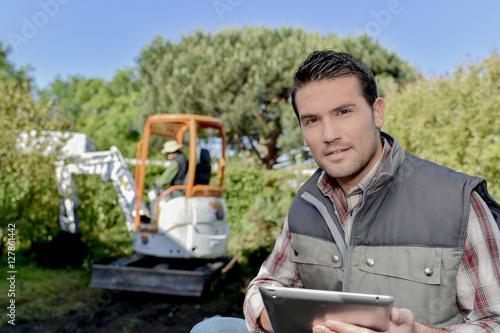 holding a tablet outdoors