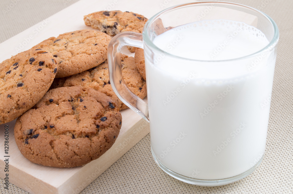 Cup with milk and oatmeal cookies Cup with milk and oatmeal cookies