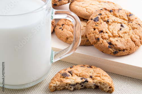 Glass cup with milk and oatmeal cookies with chocolate