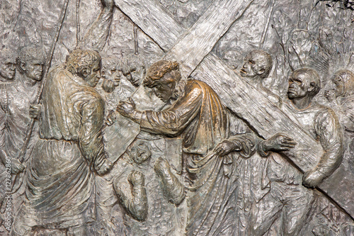 Medjugorje, Bosnia and Herzegovina, 2016/11/11. Bronze relief by Carmelo Puzzolo representing the Way of the Cross. Simon of Cyrene is helping Jesus carry the cross. photo