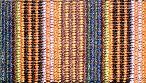 Cloth texture with many knitted thin color vertical stripes Horizontal view closeup