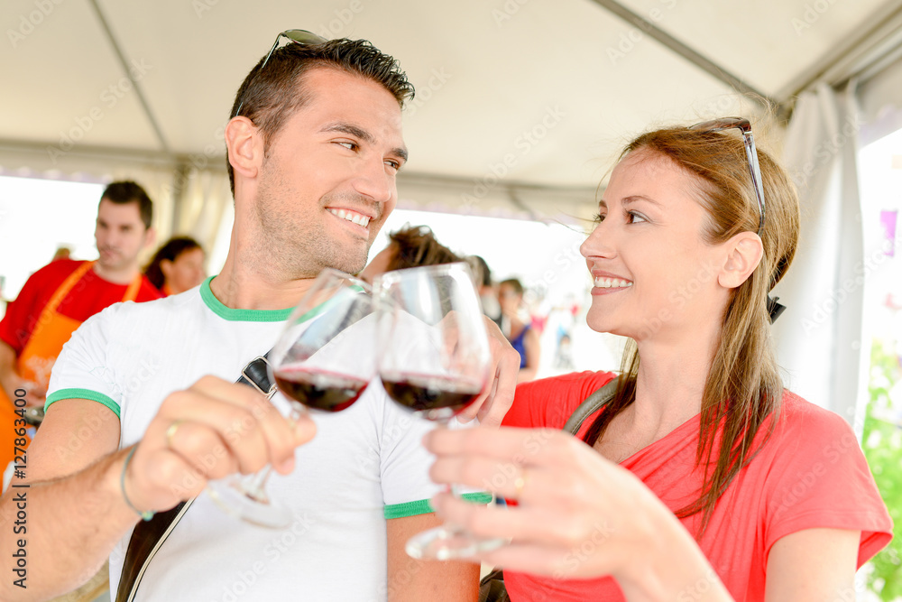 Couple toasting with red wine