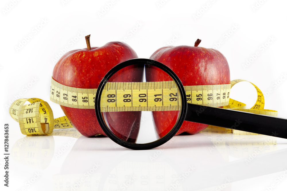 Two red apple wrapped with the meter, on a white background.
