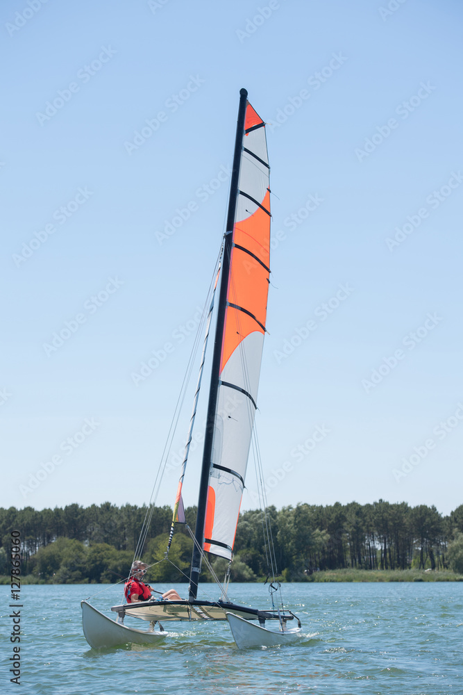 Naklejka premium sailing on a lake - summer and sports theme