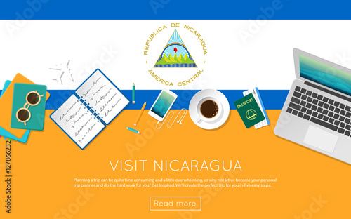 Visit Nicaragua concept for your web banner or print materials. Top view of a laptop, sunglasses and coffee cup on Nicaragua national flag. Flat style travel planninng website header.