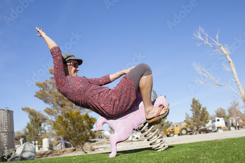 An adult woman playing cowgirl with a stylish playground performance near Lone Pine, California.