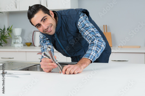 Portrait of plumber fitting kitchen tap