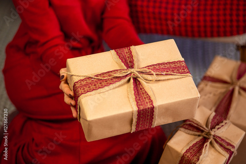 Woman with Christmas gifts in home interior, close up © olyapon