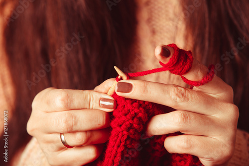 Female hands knits sweater 
