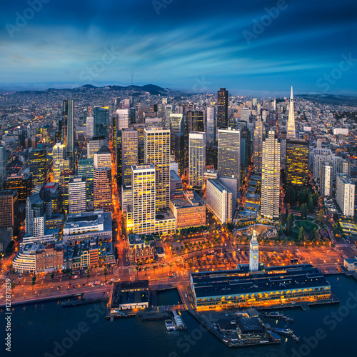 San Francisco aerial view from sea side. Port of San Francisco in the front. City downtown and skyscrapers at sunrise.