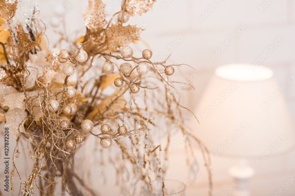 Bunch of golden frozen branches and berries in a vase. Bunch of golden frozen branches and berries in a vase.