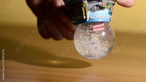 Turin, Italy-November 18, 2016: Hand turns a snow globe dedicated to the city of London
