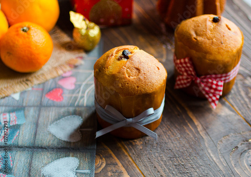 Mini panettone and pandoro, with fruits and Christmas decoration photo