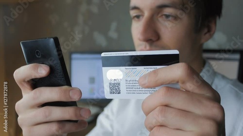 man using smartphone shopping online with credit card