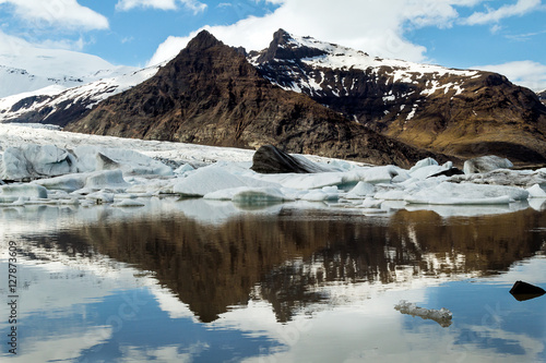 Iceberg at Jokulsarlon glacial lagoon with snow mountain background